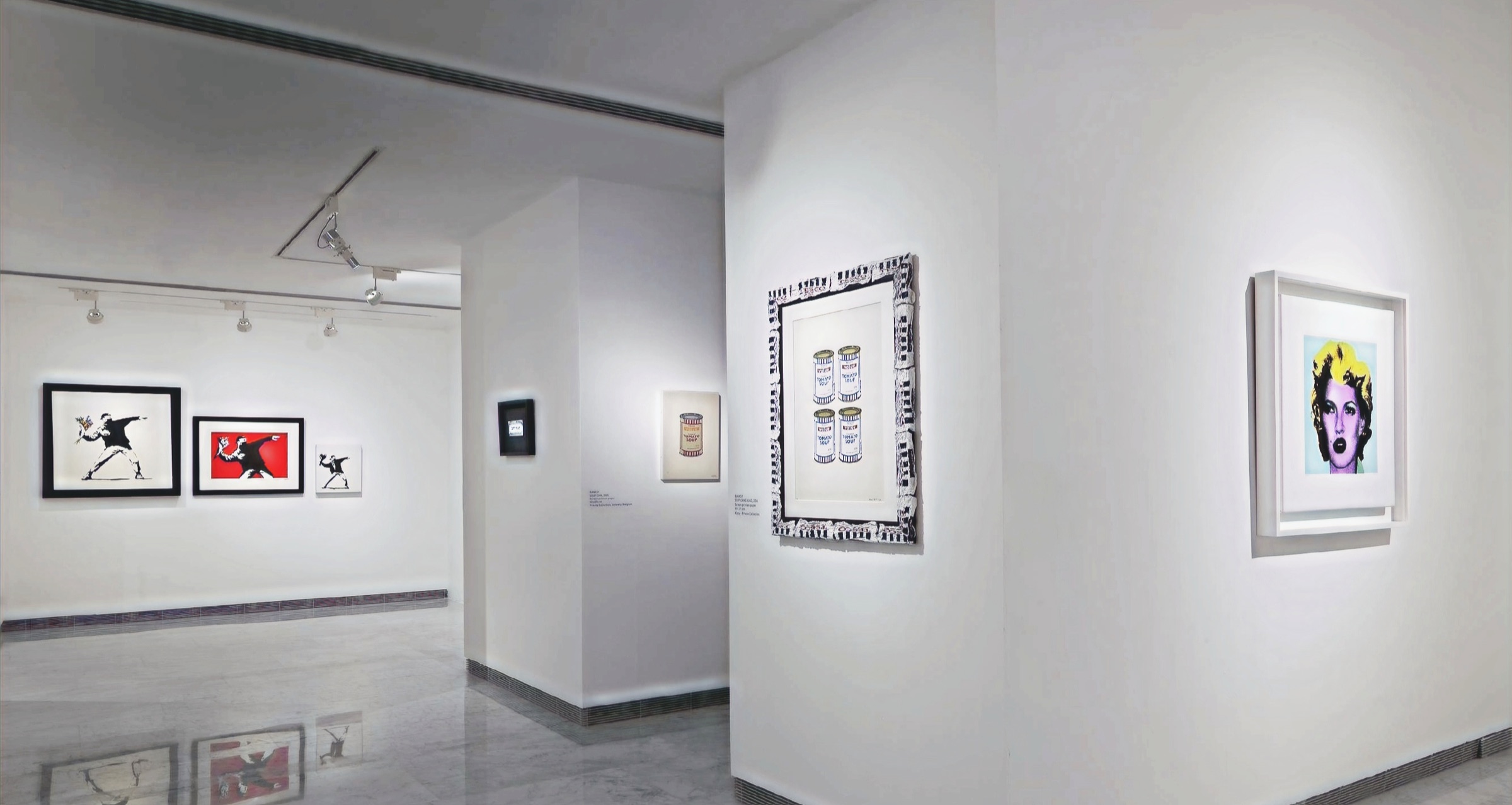 Framed works installed in the gallery